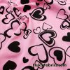 Scattered Black Outline Hearts on Pink Cotton Spandex Fabric