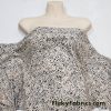Black Pebbles on a Light Vanilla Cream Background Poly Spandex Fabric