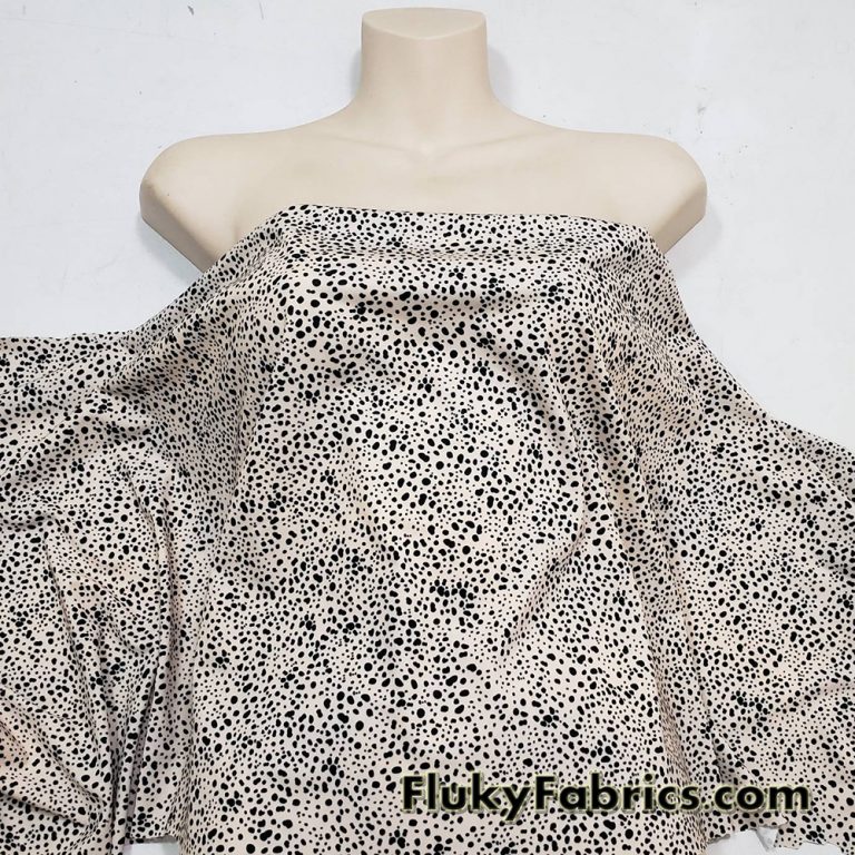 Black Pebbles on a Light Vanilla Cream Background Poly Spandex Fabric