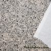 Black Pebbles on a Light Vanilla Cream Background Poly Spandex Fabric