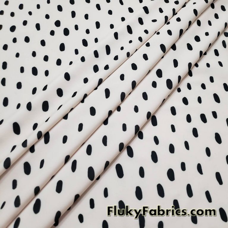 On Trend Black Irregular Oval Dots Print on an Ivory Background Nylon Spandex Fabric