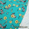 Raccoons, Hummingbirds and Sunflowers on Aqua Cotton Spandex Fabric